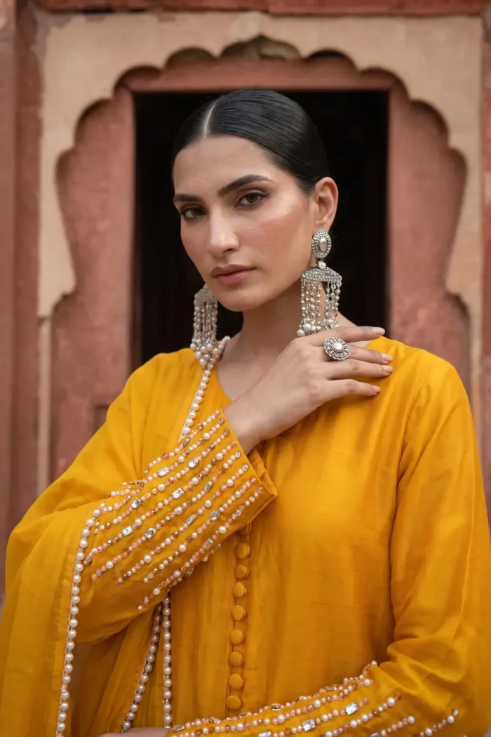 ZAR-E-BAHAR mustard yellow tissue silk outfit with pearl and crystal cuff close-up | AYZAL HASSAN